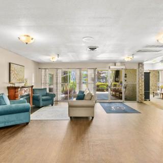 A spacious, bright lobby area with comfortable seating and decorative lighting.