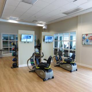 A well-equipped gym area featuring elliptical machines and a spacious, inviting atmosphere.