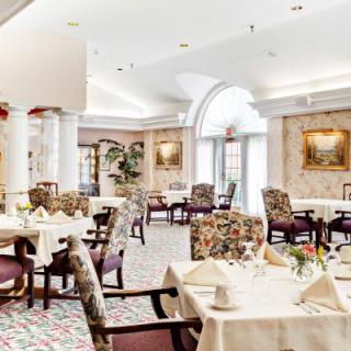 An elegant restaurant dining area with beautifully set tables and classic decor.