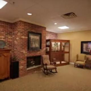 A cozy living room with a brick fireplace and comfortable seating.