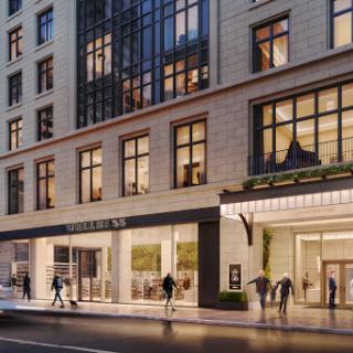 A modern commercial building featuring large windows and an inviting entrance, set in an urban environment.