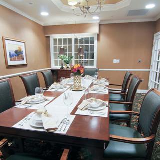 A well-appointed dining or conference room with an elegant table setting and comfortable chairs.