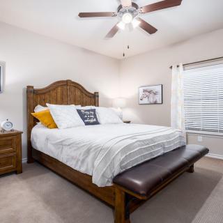 A cozy bedroom with a large wooden bed and stylish decor.