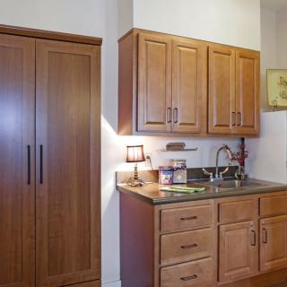 A modern kitchen interior with wooden cabinets and a sink.