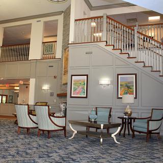 Stylish hotel lobby featuring a staircase and seating area.