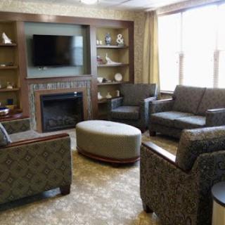 A cozy living room setup featuring comfortable seating, a television, and a fireplace.