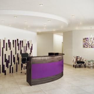 A stylish and modern reception area featuring purple accents and contemporary furniture.