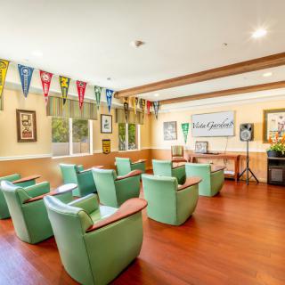 A cozy meeting room with comfortable chairs and colorful pennants hanging from the walls.