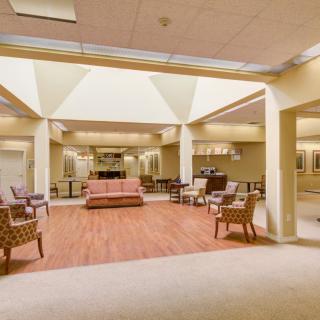 A spacious lobby with comfortable seating and soft lighting.