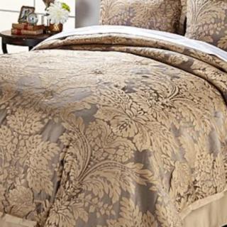 A luxurious comforter set with an intricate floral pattern, adding elegance to the bedroom decor.