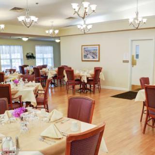 An elegantly arranged dining room with tables set for guests.