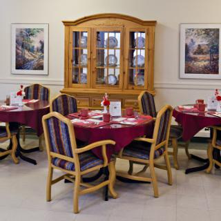 A cozy dining area with round tables and elegant wooden furniture.