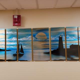 A serene landscape painting featuring a lighthouse, sailboats, and a tranquil sea under a beautiful night sky.