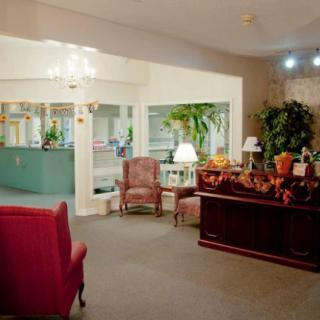 A cozy lobby area featuring comfortable seating, indoor plants, and decorative lighting.