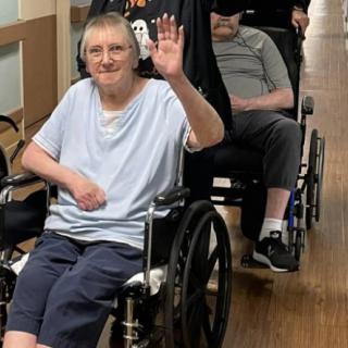 Elderly individuals in wheelchairs enjoying their time indoors.