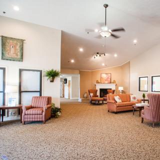 A spacious lobby area with comfortable seating and warm lighting.
