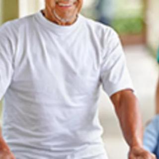An elderly person walking outdoors.