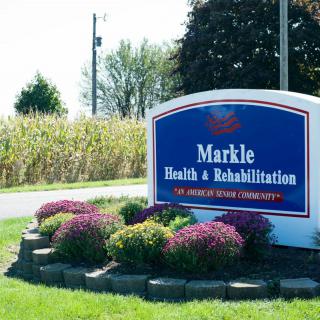 Entrance sign for Markle Health & Rehabilitation surrounded by landscaping and flowers.