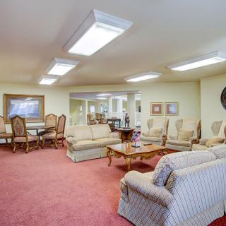 A spacious living room with comfortable seating and elegant decor.