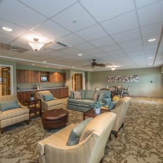 A spacious and elegantly decorated lounge with comfortable seating and warm lighting.