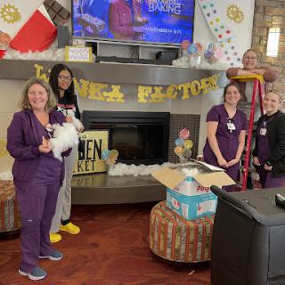 A joyful gathering of caregivers celebrating with decorations and a cozy atmosphere.