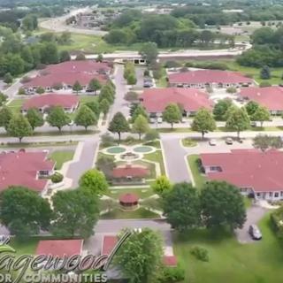 Aerial view of a beautifully designed residential community featuring well-maintained buildings and green spaces.