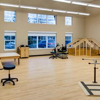 A spacious physical therapy room equipped with various rehabilitation tools.