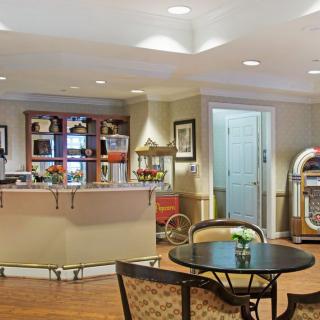 A retro-themed diner interior featuring a jukebox and a cozy seating area.