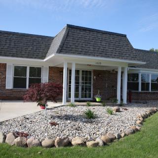A charming single-story house with landscaped front yard.