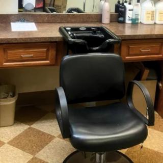 A barber chair in a salon setting, ready for the next client.