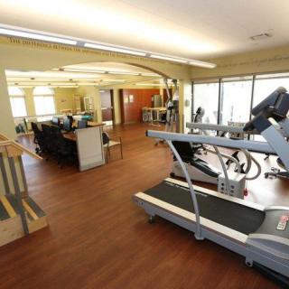 A spacious gym area featuring exercise equipment including treadmills and other fitness machines.