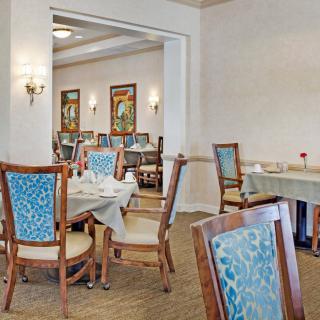 A spacious dining area with elegant decor and neatly arranged tables and chairs.