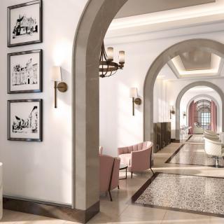 A modern and elegant hallway featuring archways and contemporary artwork on the walls.