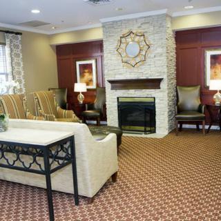 A cozy living room with a fireplace and comfortable seating arrangements.