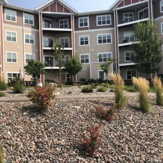 A multistory apartment building with landscaped grounds.