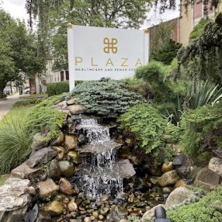 A serene waterfall landscape featuring a welcoming plaza sign.