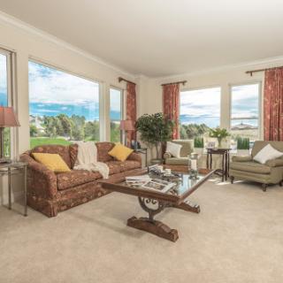 A cozy living room bathed in natural light, featuring comfortable seating and stylish decor.