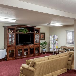 A cozy living room with a large entertainment center and comfortable seating.