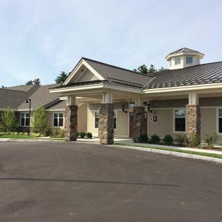 A modern residential facility with a welcoming entrance and manicured surroundings.