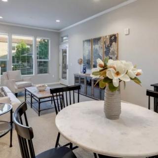 A modern living and dining area with a marble table and elegant decor.