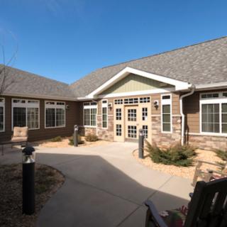 A courtyard view of a residential building with brick exterior and multiple windows.
