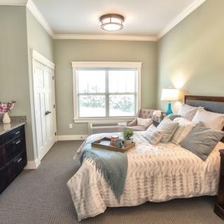 A cozy and modern bedroom interior with elegant decor and natural lighting.