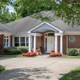 A charming residential house with a landscaped front yard and inviting entrance.