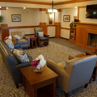A cozy living room with comfortable seating, a fireplace, and decorative elements.