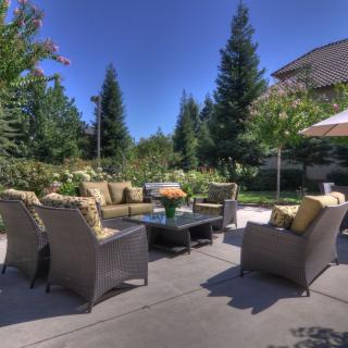A beautiful outdoor patio area with comfortable seating and lush greenery.