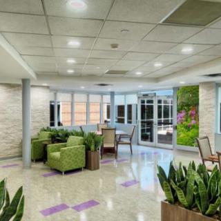 A modern waiting room with comfortable seating and large windows.