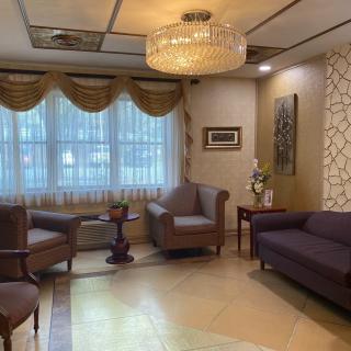 A well-decorated living room with comfortable seating and elegant lighting.