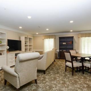 A cozy living room with comfortable seating, a television, and a dining area.