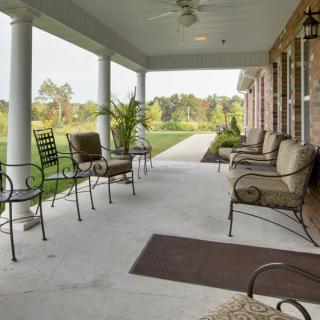 A spacious porch with outdoor seating and a scenic view.