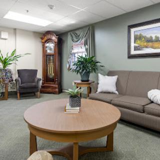 A cozy living room featuring comfortable seating and a stylish coffee table with greenery.